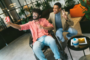 Two men in wheelchairs taking a selfie.