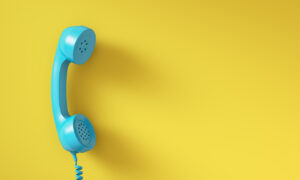 Blue vintage phone on yellow background