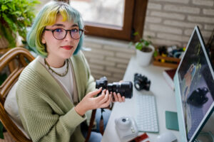 Millennial photographer working on her photos at home office