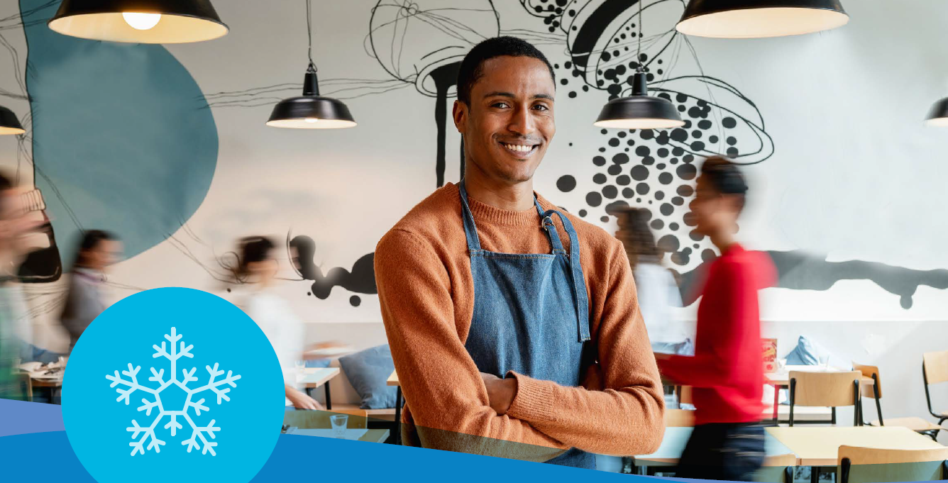 Cafe employee poses for smile during busy shift