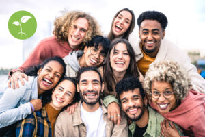 Multi ethnic guys and girls taking selfie outdoors with backlight - Happy life style friendship concept on young multicultural people having fun day together in Barcelona - Bright vivid filter |