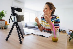 Caucasian woman recording her video tutorial at home.
