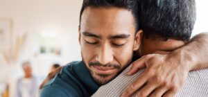 a father and son hugging