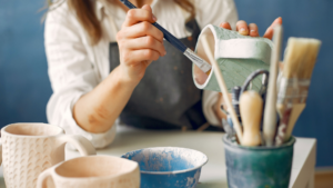 Woman painting ceramics