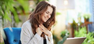 happy woman in sunny day having online meeting