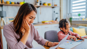 Women looking at financial papers next to her daughter