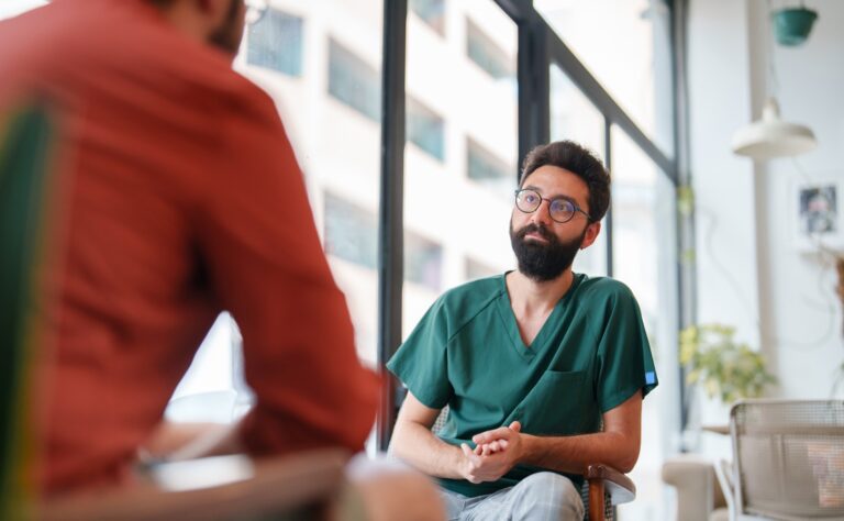 Healthcare worker at a sidewalk cafe after work with a friend