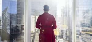 business women looking out office window