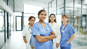 Diverse health-care providers stand together in a hallway.