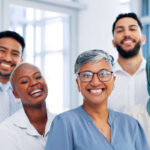 A group of diverse healthcare providers stand together