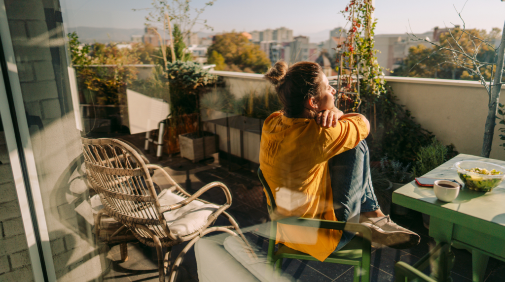 A woman sitting on a balcony enjoying her surroundings