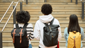 Three students walking up stairs