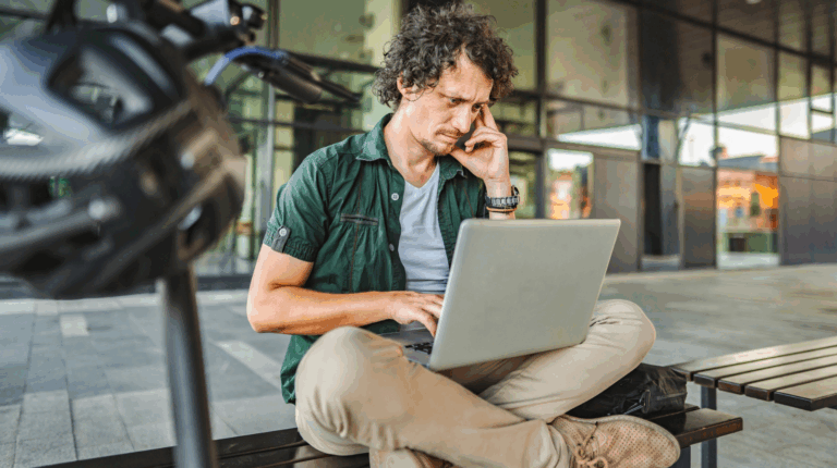 An anxious man staring at his laptop