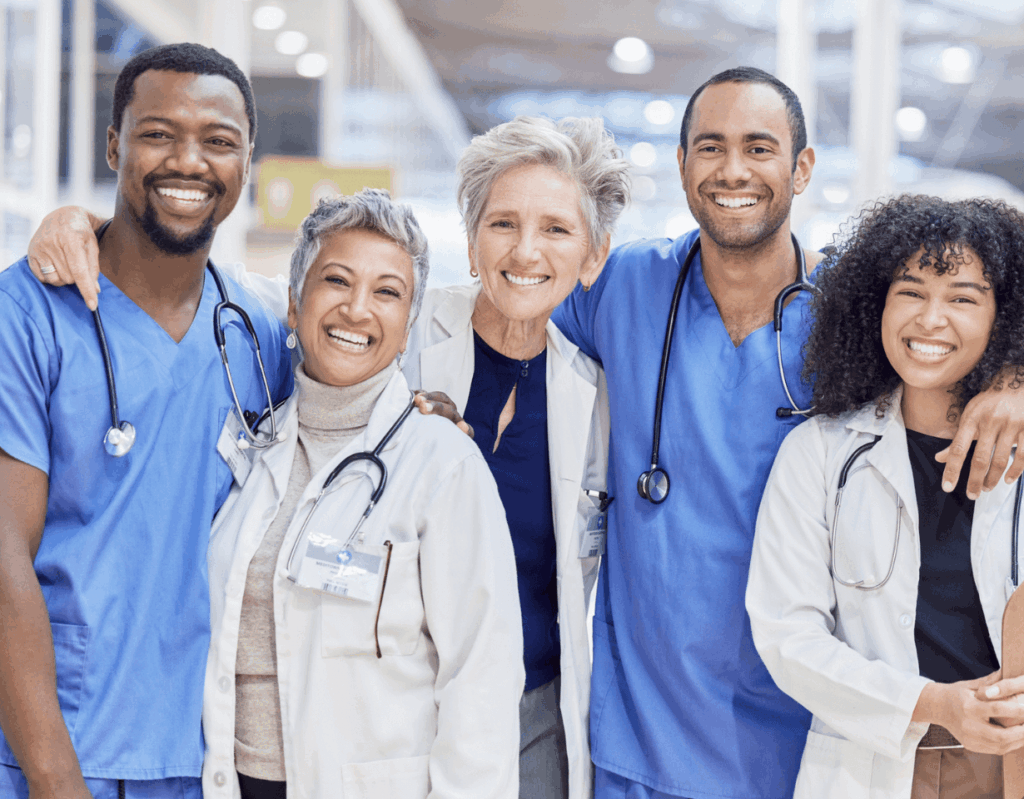 A group of doctors and nurses smiling at the camera