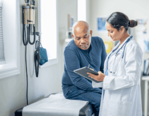 A patient and doctor look over a file