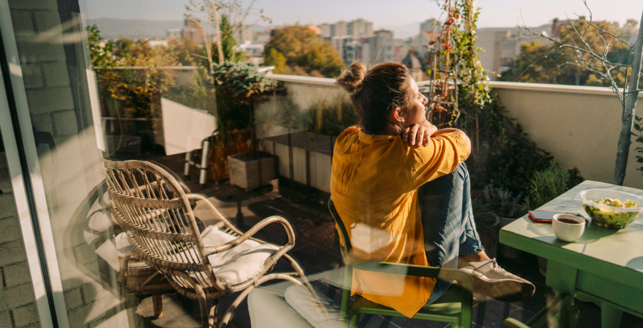 A woman sitting on a balcony enjoying her surroundings