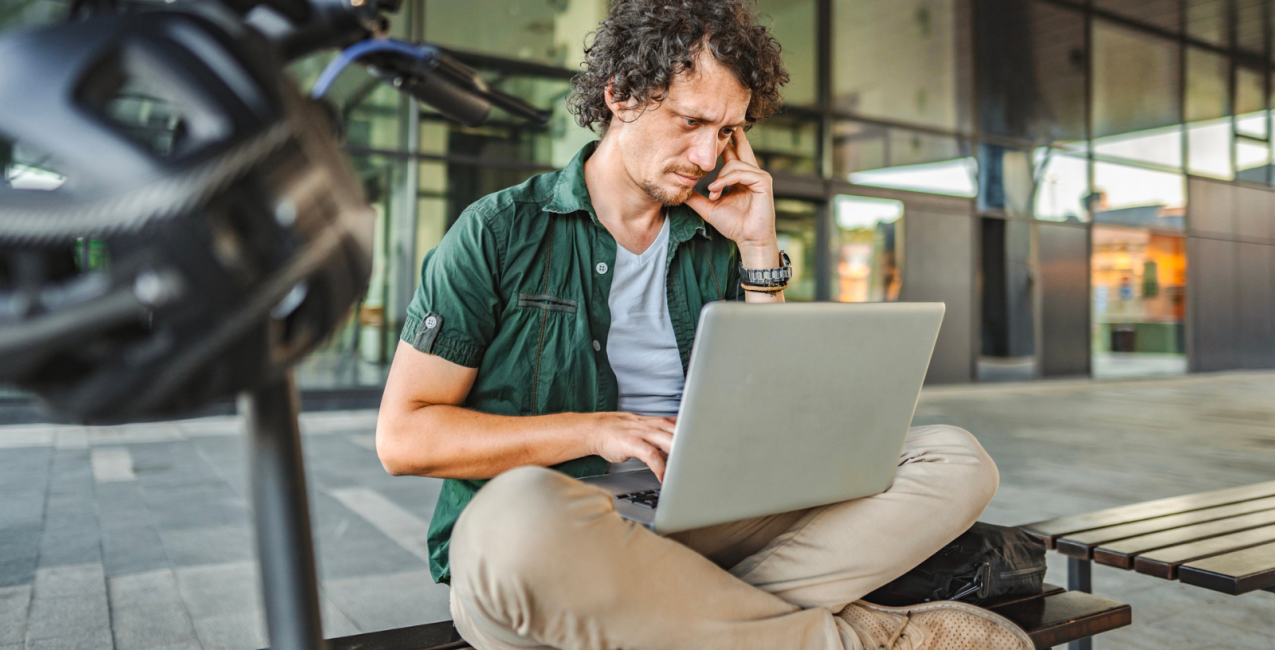 An anxious man staring at his laptop