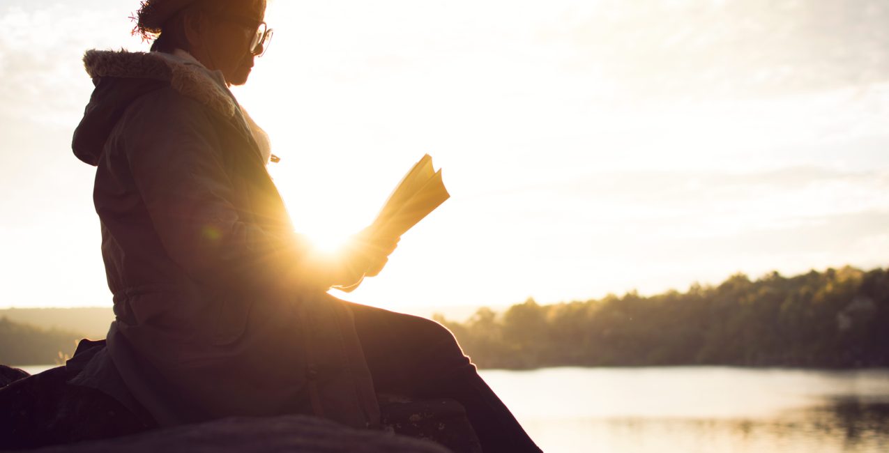 Woman reading a book in nature